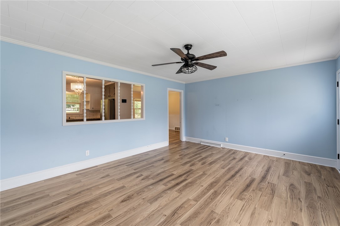 12 Dendy Street Pelzer, SC 29669 - Photo 4 of 31 A living space offers resilient flooring and a ceiling fan for comfort.