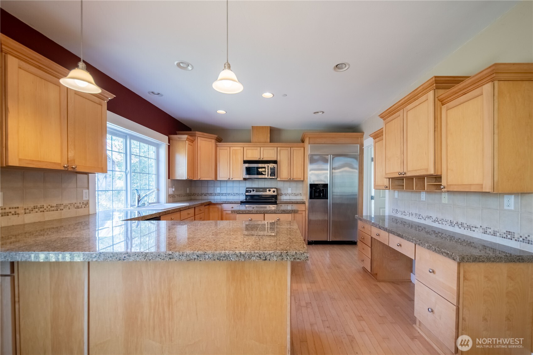 26013 Old Owen Road Monroe, WA 98272 - Photo 9 of 30 a large kitchen with stainless steel appliances granite countertop a refrigerator a stove top oven a sink and dishwasher with wooden floor