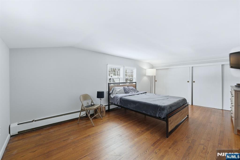 207 Elm Avenue Hackensack, NJ 07601 - Photo 19 of 38 a bedroom with a bed and wooden floor