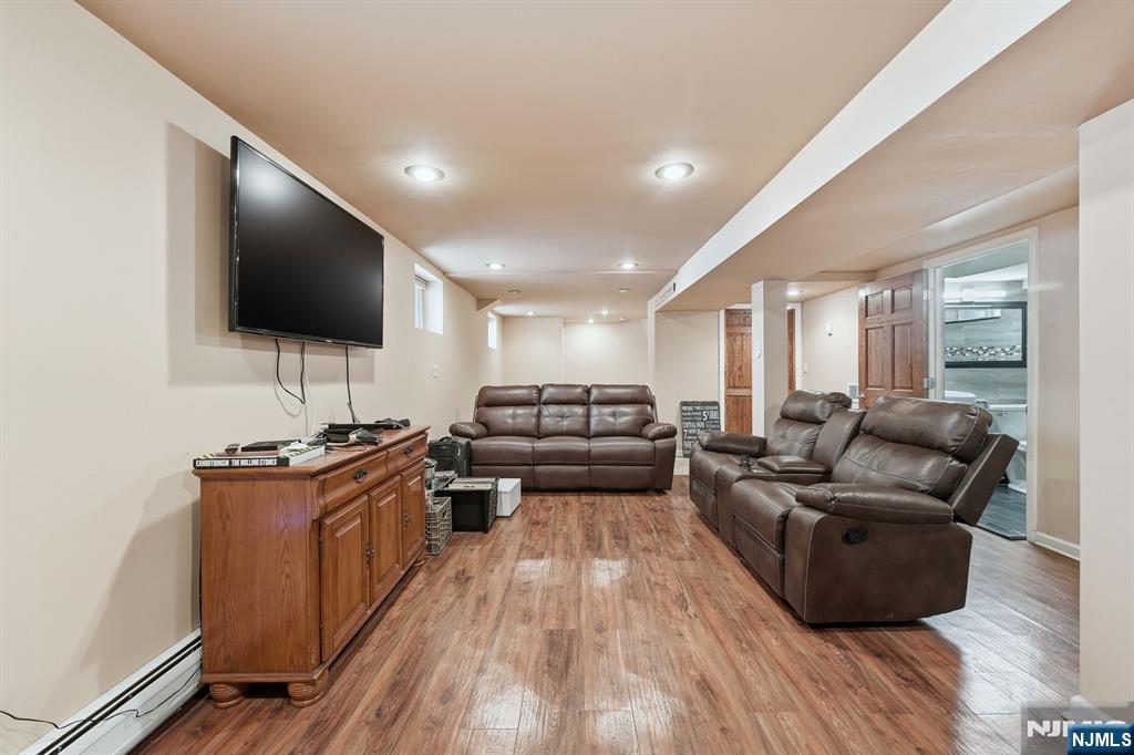 207 Elm Avenue Hackensack, NJ 07601 - Photo 26 of 38 a living room with furniture and a flat screen tv