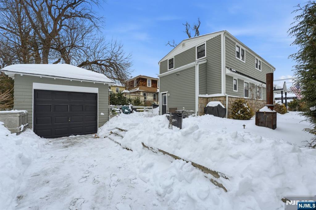 207 Elm Avenue Hackensack, NJ 07601 - Photo 30 of 38 a front view of a house with a yard covered in snow