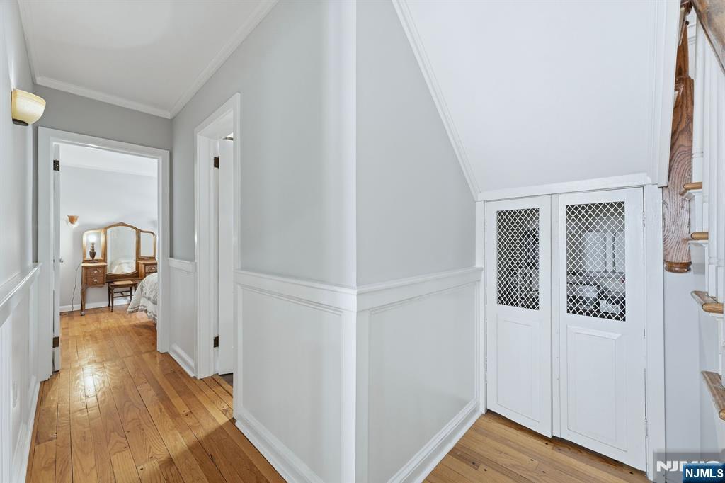 207 Elm Avenue Hackensack, NJ 07601 - Photo 10 of 38 a view of a hallway with wooden floor and staircase
