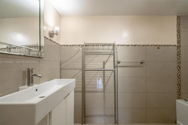a bathroom with a sink and mirror