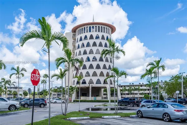 a view of a cars park in front of a building