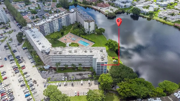 an aerial view of a house with a yard and lake view