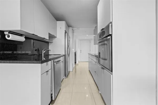 a kitchen with stainless steel appliances a refrigerator and a stove