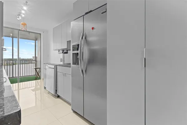 a kitchen with stainless steel appliances a refrigerator and a sink