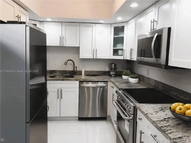 a bathroom with a sink and a washer dryer