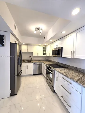 a en suite bathroom with a sink and a large mirror