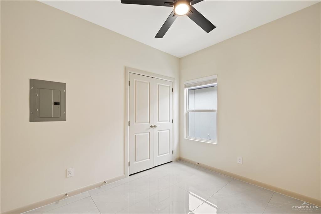1806 West Violet Drive, Unit 4 Pharr, TX 78577 - Photo 6 of 11 an empty room with windows and fan