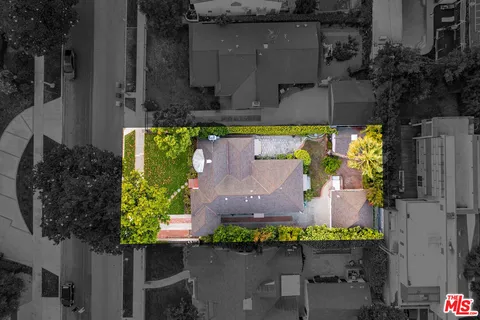 an aerial view of a house with a swimming pool
