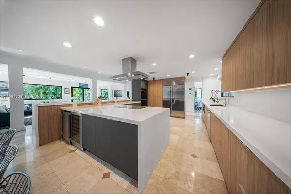 a kitchen with kitchen island granite countertop a sink and counter top space