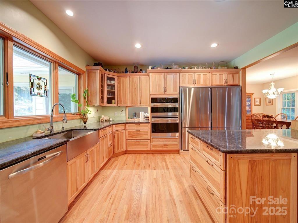 1239 John G Richards Road Camden, SC 29020 - Photo 20 of 30 a large kitchen with kitchen island granite countertop a large window and stainless steel appliances