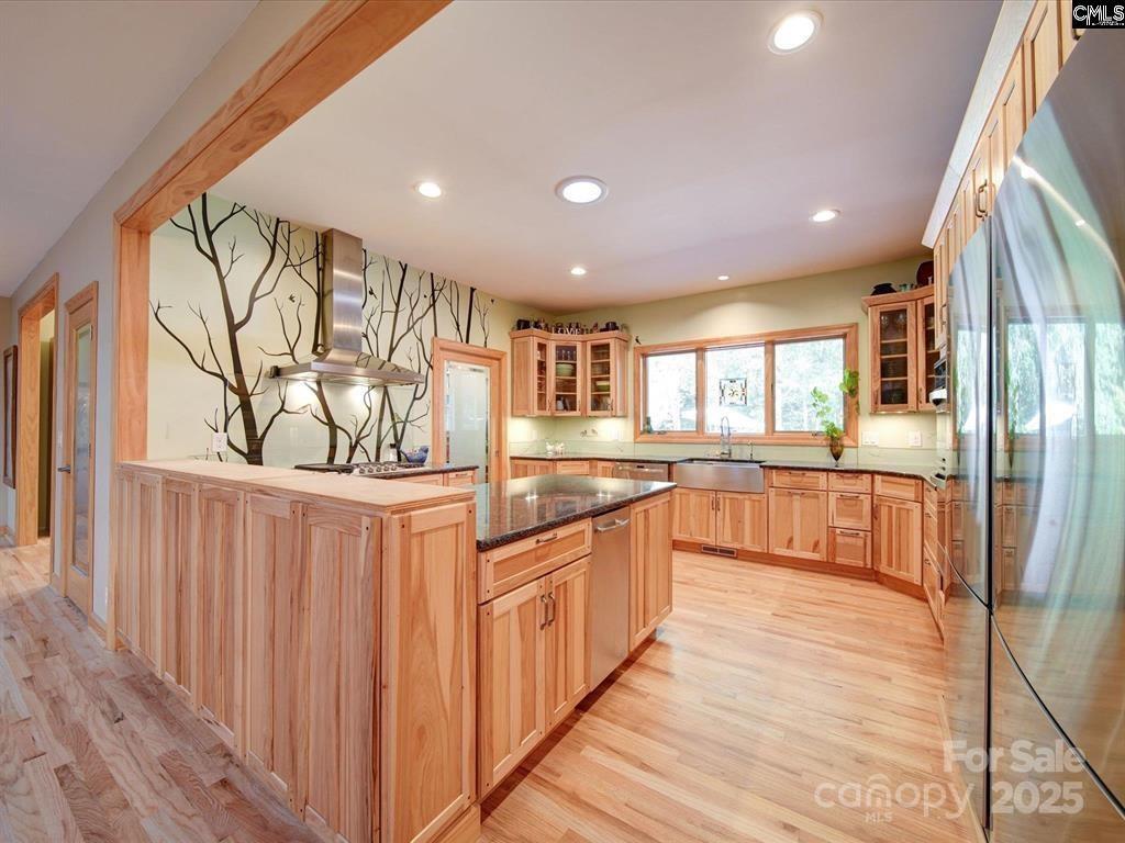 1239 John G Richards Road Camden, SC 29020 - Photo 22 of 30 a large kitchen with stainless steel appliances granite countertop a large counter top and a wooden floors