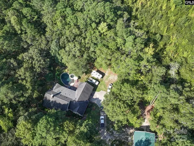 an aerial view of a house with outdoor space and street view