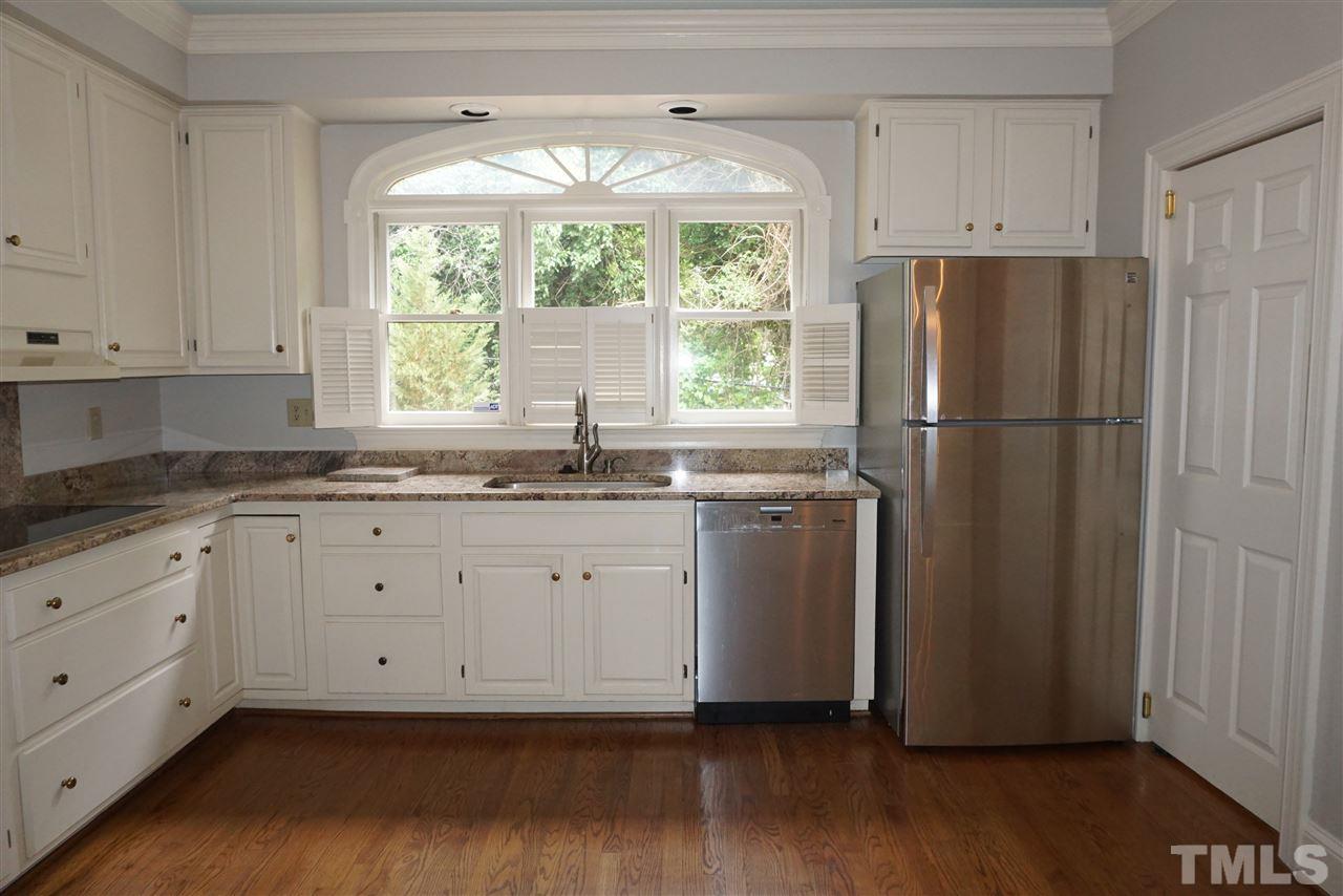 3330 Ridgecrest Court Raleigh, NC 27607 - Photo 4 of 25 a kitchen with appliances cabinets a sink and a window