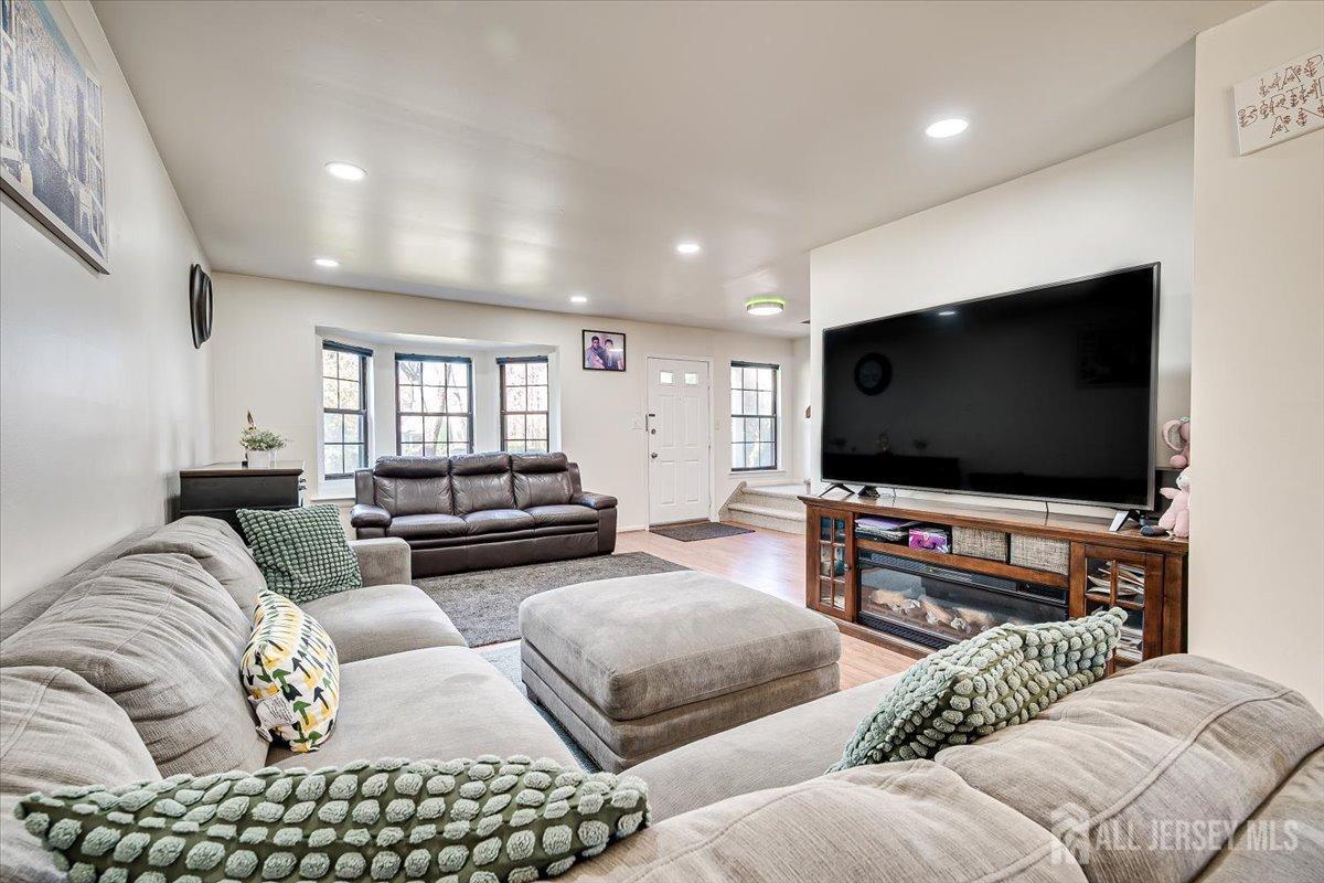 602 Maplecrest Road Edison, NJ 08820 - Photo 12 of 42 a living room with furniture and a flat screen tv