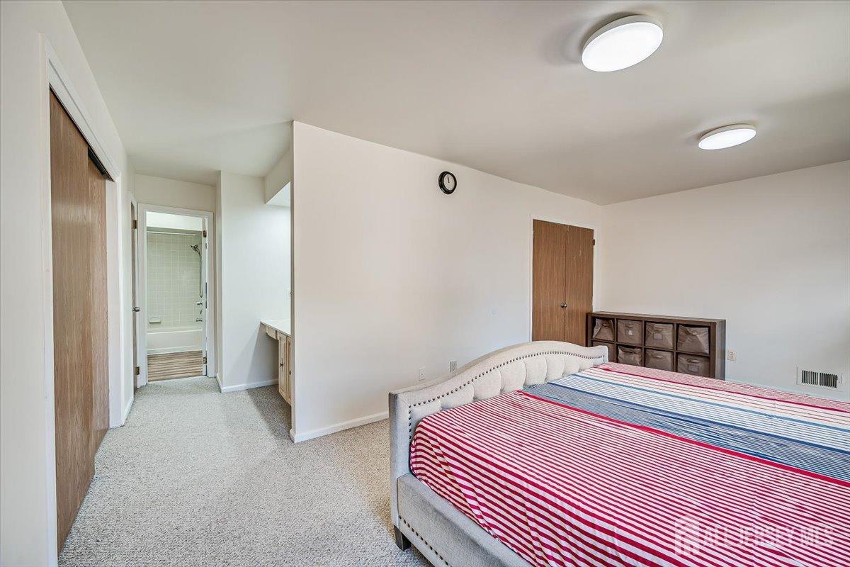 602 Maplecrest Road Edison, NJ 08820 - Photo 24 of 42 a bedroom with a bed and a lamp
