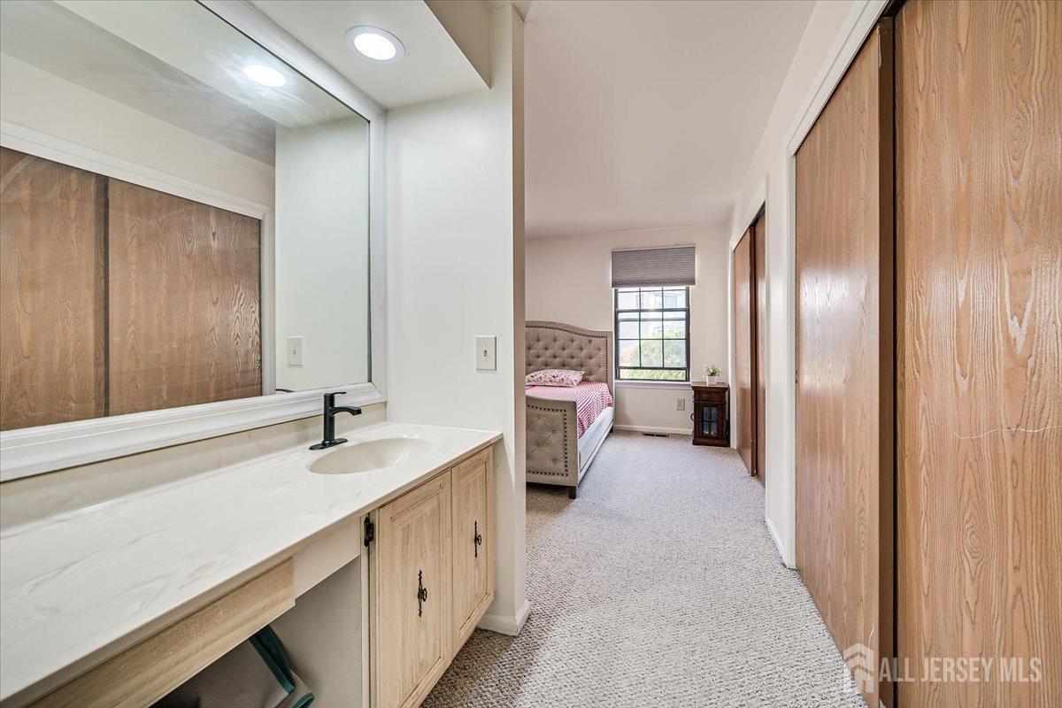 602 Maplecrest Road Edison, NJ 08820 - Photo 27 of 42 a bathroom with a sink double vanity and a mirror