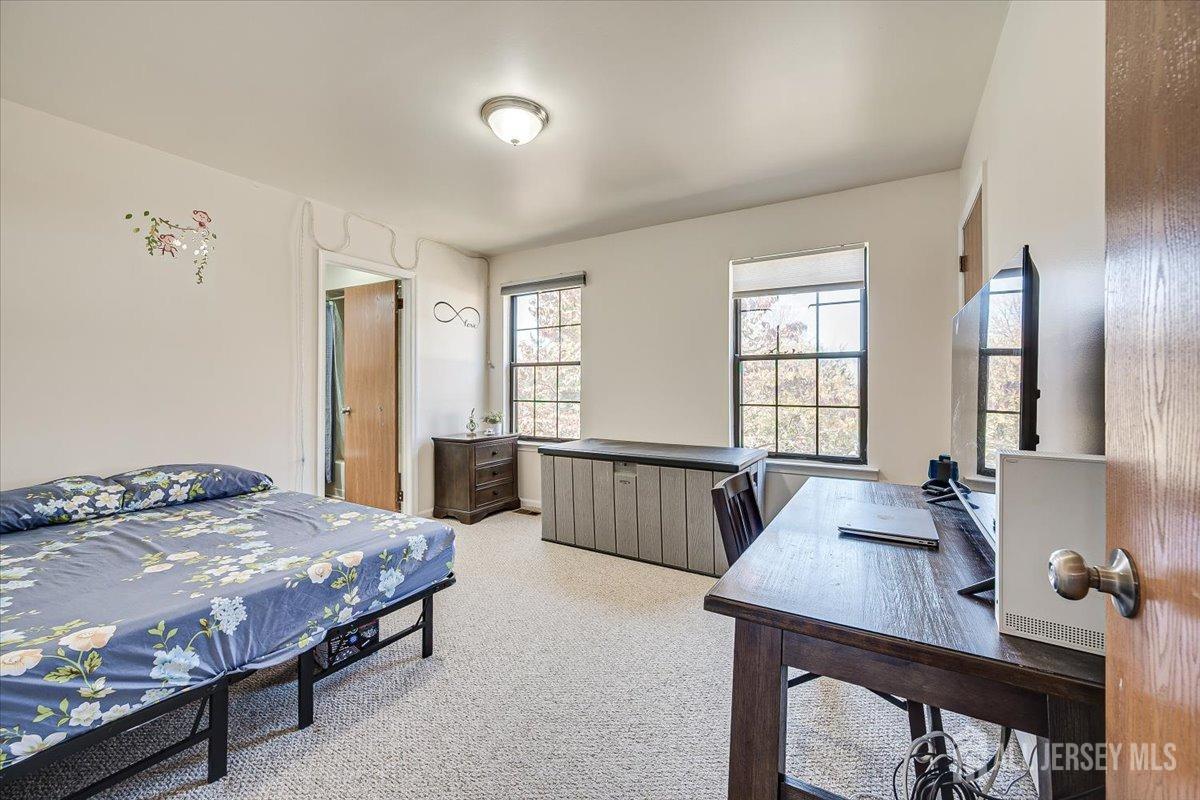 602 Maplecrest Road Edison, NJ 08820 - Photo 29 of 42 a bedroom with a bed and a table