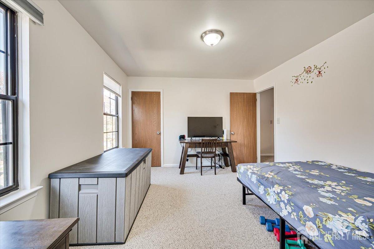 602 Maplecrest Road Edison, NJ 08820 - Photo 31 of 42 a bedroom with a bed and a flat screen tv