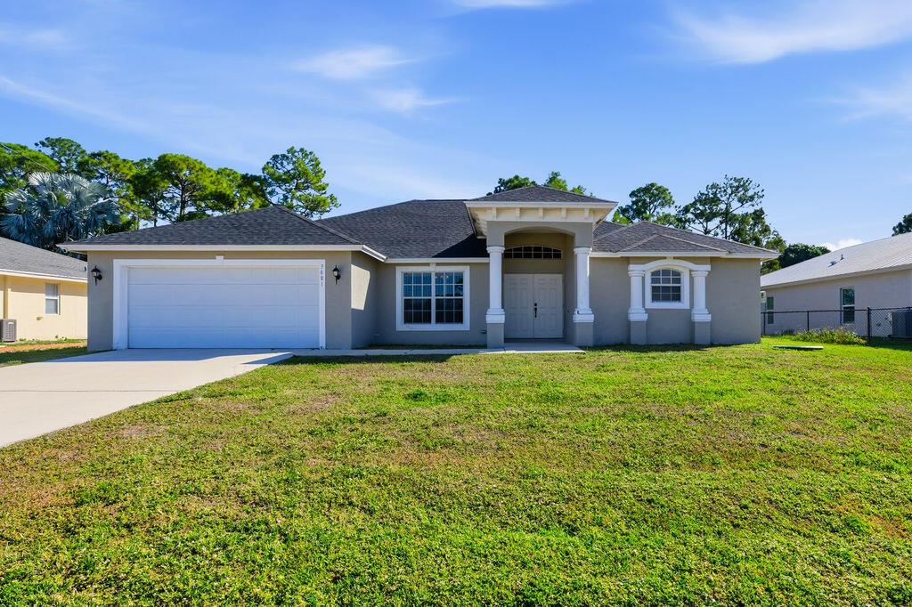 a front view of a house with a garden