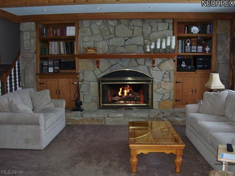 Relax in this 22 x 17 Great Room with raised hearth stone fireplace, built in book-shelves and newer carpet.