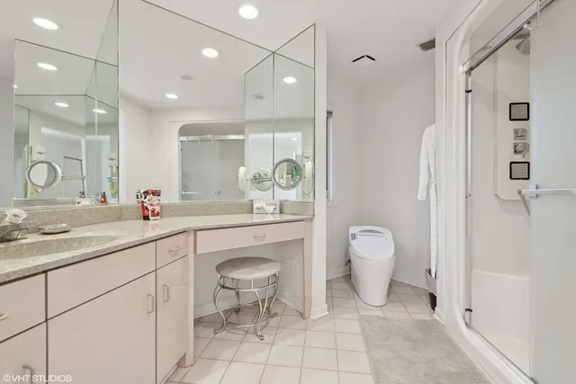 a spacious bathroom with a granite countertop sink a toilet and a shower