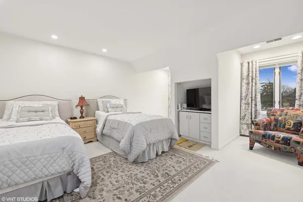 a bedroom with two beds and a window