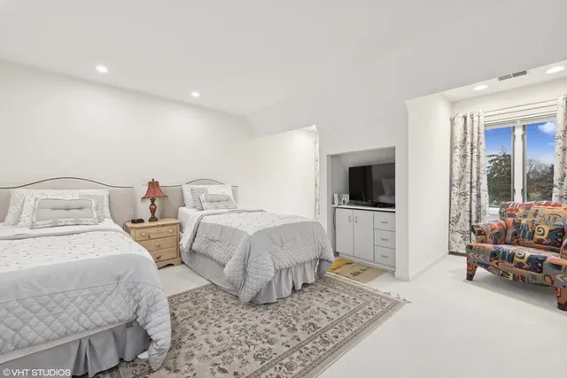 a bedroom with two beds and a window