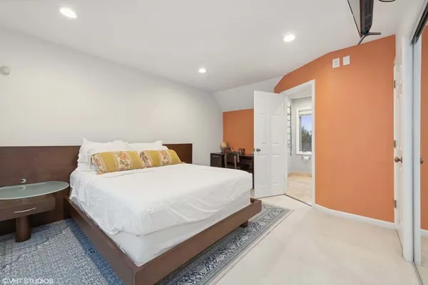 a large bedroom with a bed and a table