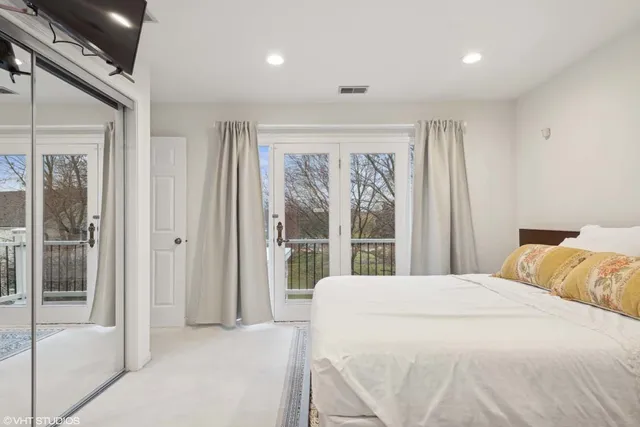 a bedroom with a large bed and a large window