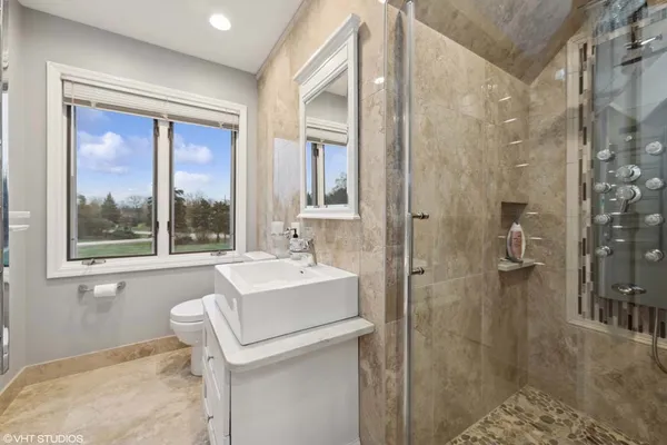 a bathroom with a sink toilet and shower