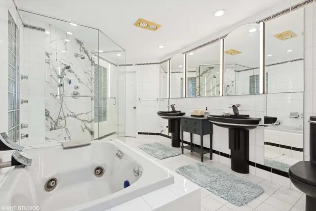 a bathroom with a tub sink and mirror