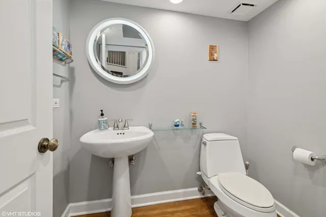 a bathroom with a sink a mirror and toilet