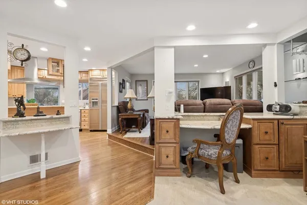 a view of kitchen with sink stainless steel appliances and living room