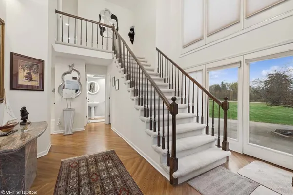a view of entryway and hall with wooden floor