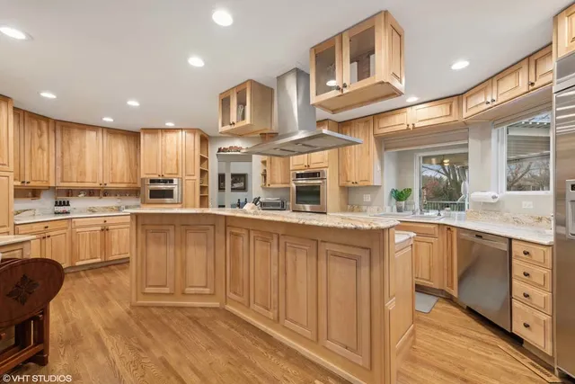 a kitchen with stainless steel appliances granite countertop a sink and cabinets