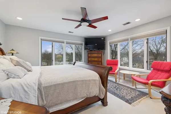 a bedroom with a bed and glass window