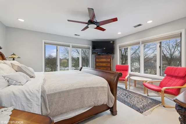 a bedroom with a bed and glass window