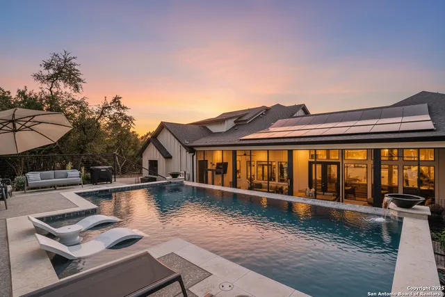 a view of a patio with table and chairs barbeque potted plants and large tree