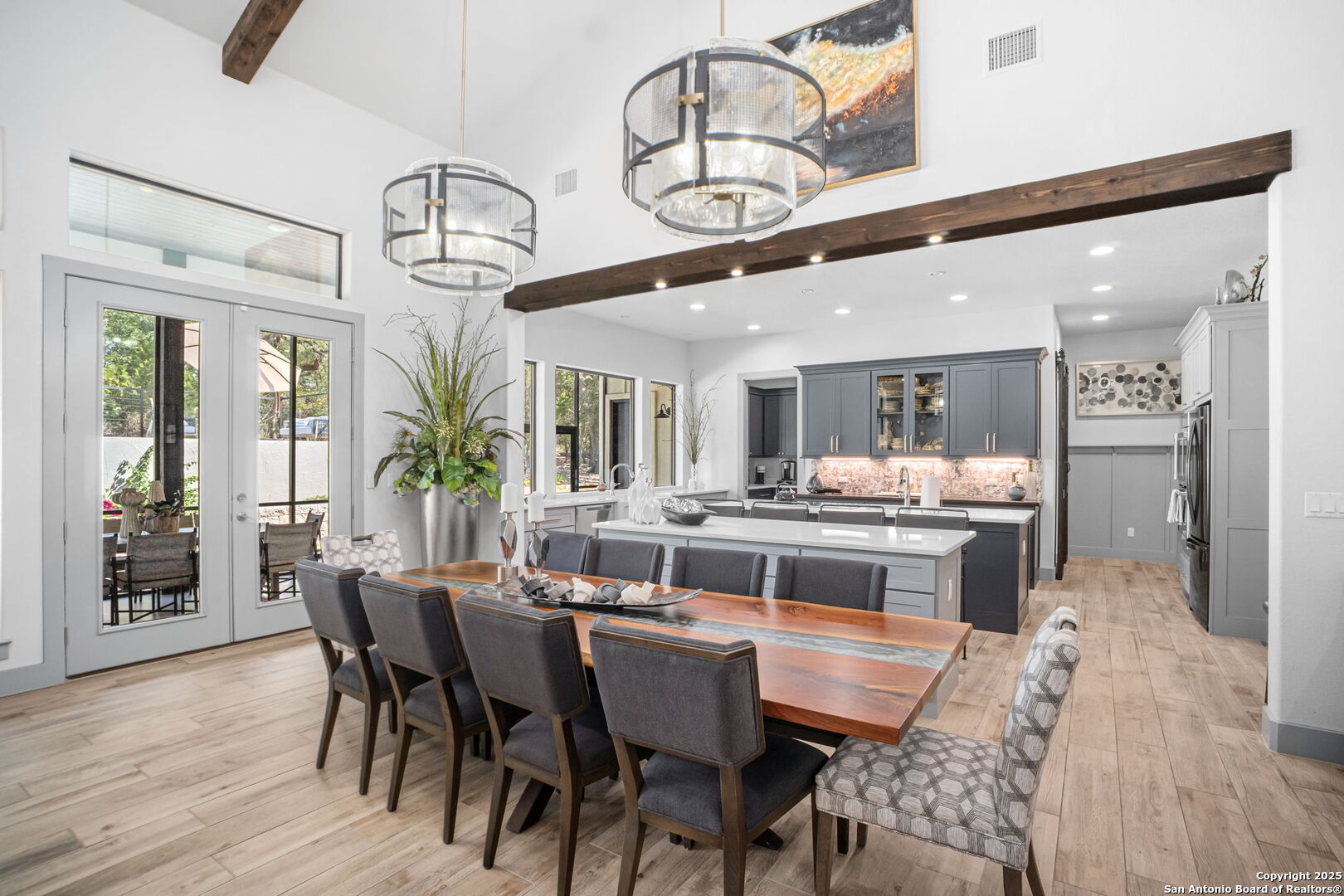 2016 Brunello New Braunfels, TX 78132 - Photo 16 of 53 a dining room with wooden floor a chandelier a wooden table and chairs