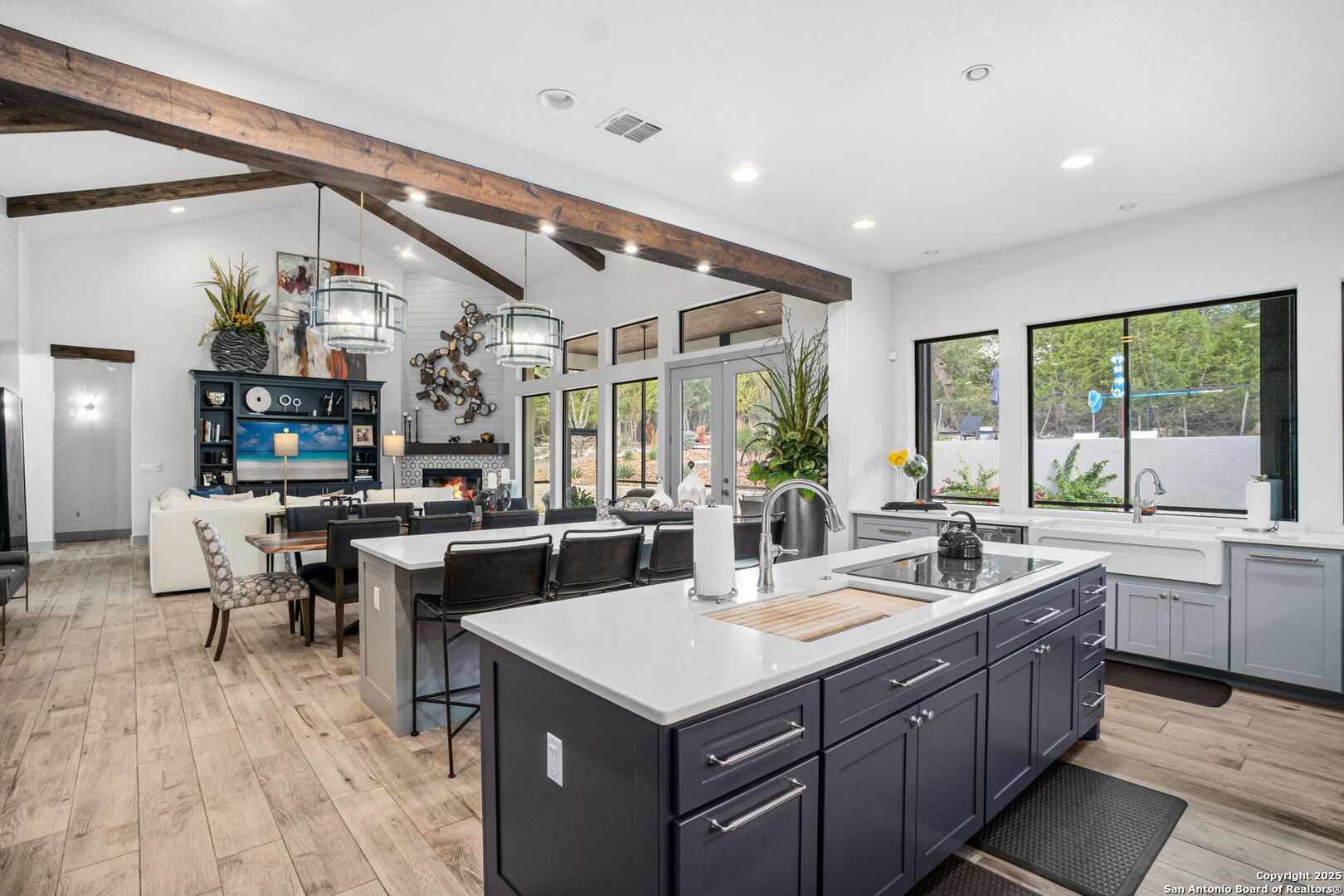 2016 Brunello New Braunfels, TX 78132 - Photo 18 of 53 a kitchen with a stove a sink dishwasher kitchen island with couches and potted plants with wooden floor