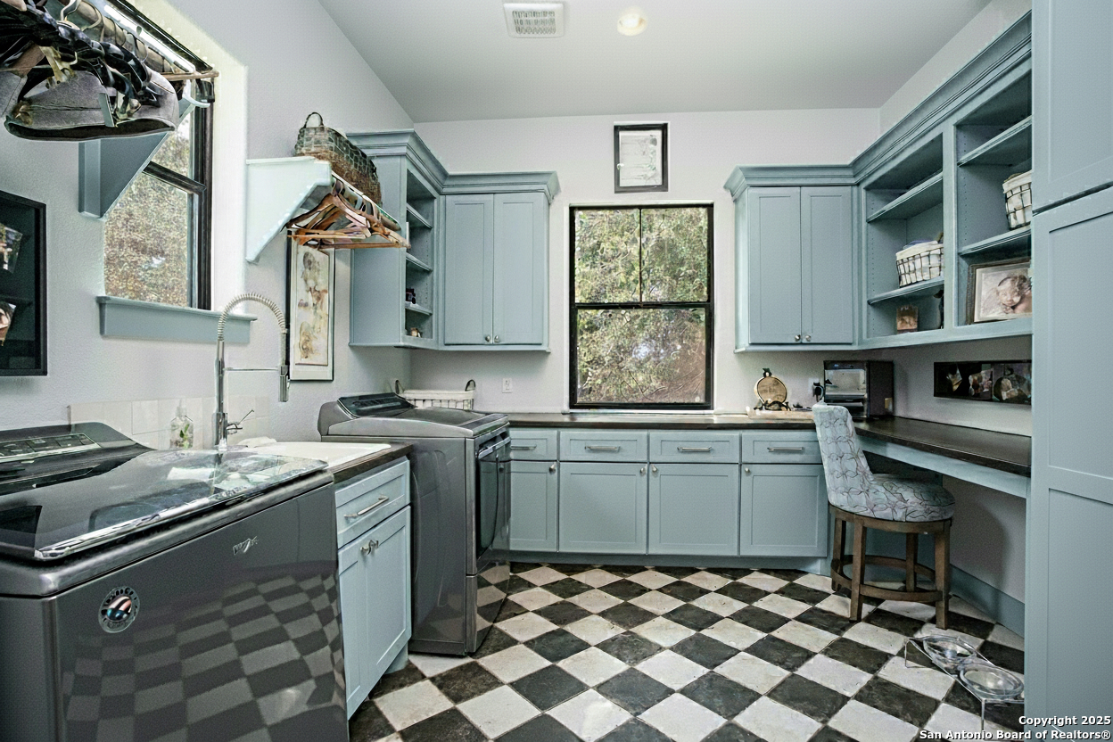 2016 Brunello New Braunfels, TX 78132 - Photo 23 of 53 a kitchen with a sink a stove a window and cabinets