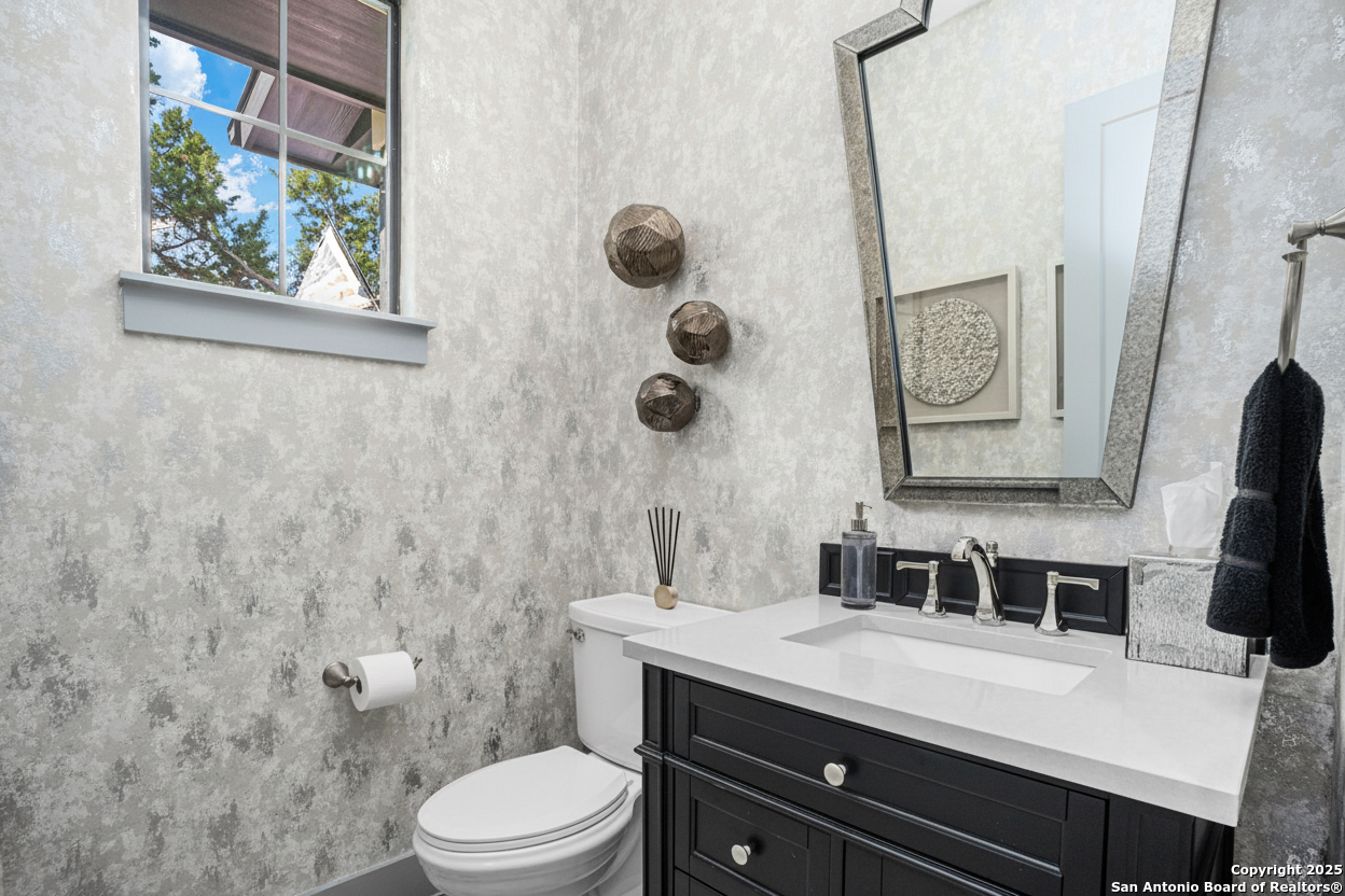 2016 Brunello New Braunfels, TX 78132 - Photo 30 of 53 a bathroom with a granite countertop sink toilet and mirror