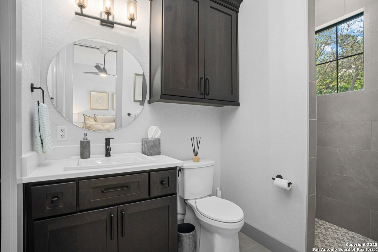 2016 Brunello New Braunfels, TX 78132 - Photo 32 of 53 a bathroom with a granite countertop sink toilet and mirror