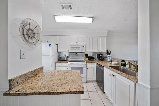 a kitchen with a sink a stove and cabinets