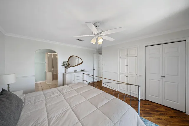 a bedroom with a bed and a chandelier
