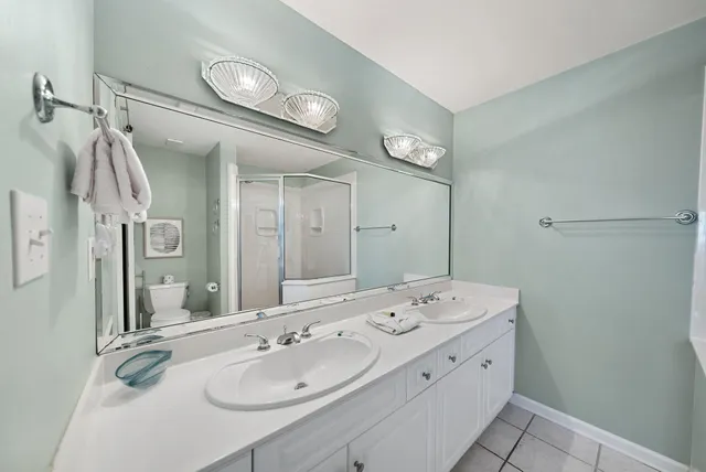 a bathroom with a double vanity sink mirror and double