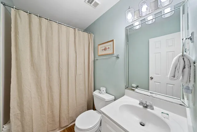a bathroom with a sink a mirror and a toilet